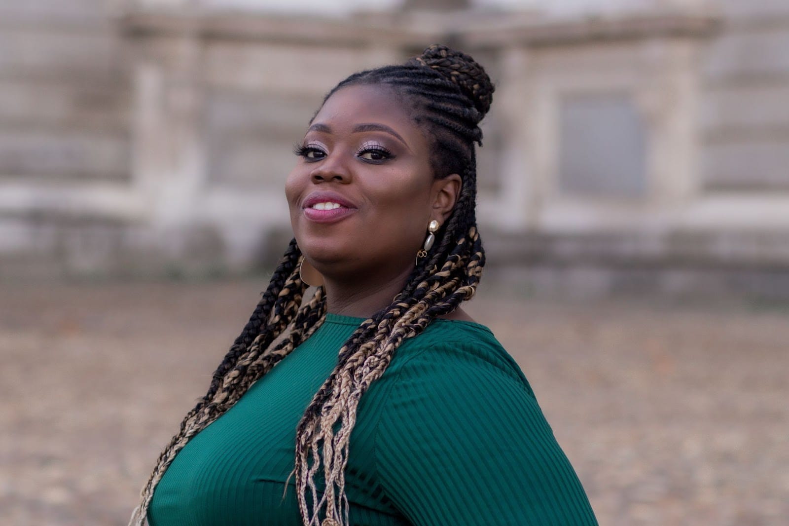Josette Ricketts wearing green, looking confidently toward the camera